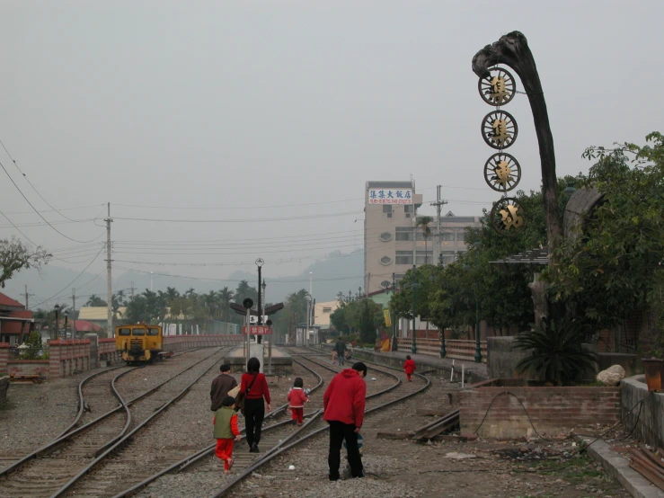 two people on a train track in the rain