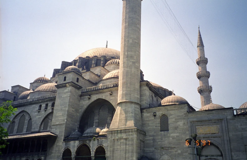 an ornate building with several spires against a blue sky