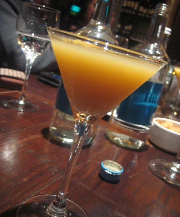 a cocktail sits on a table with a glass