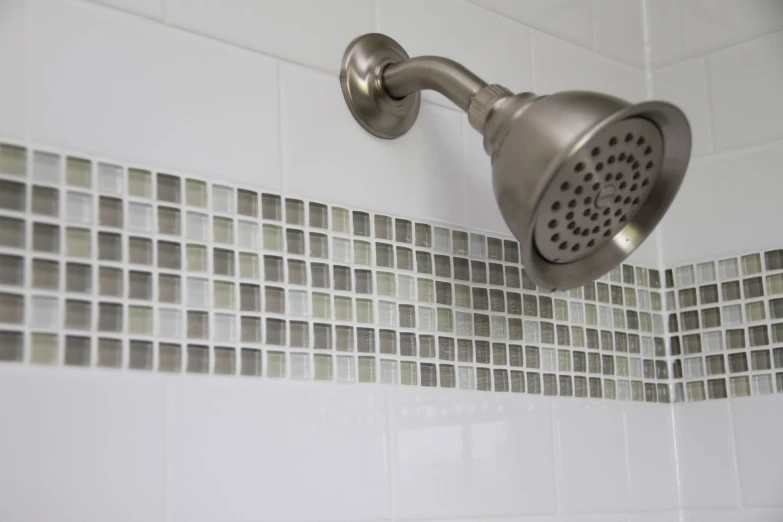 this is a shower head with a tiled back splash