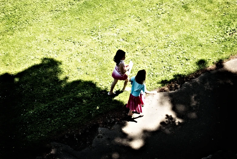 two girls are walking around in the park