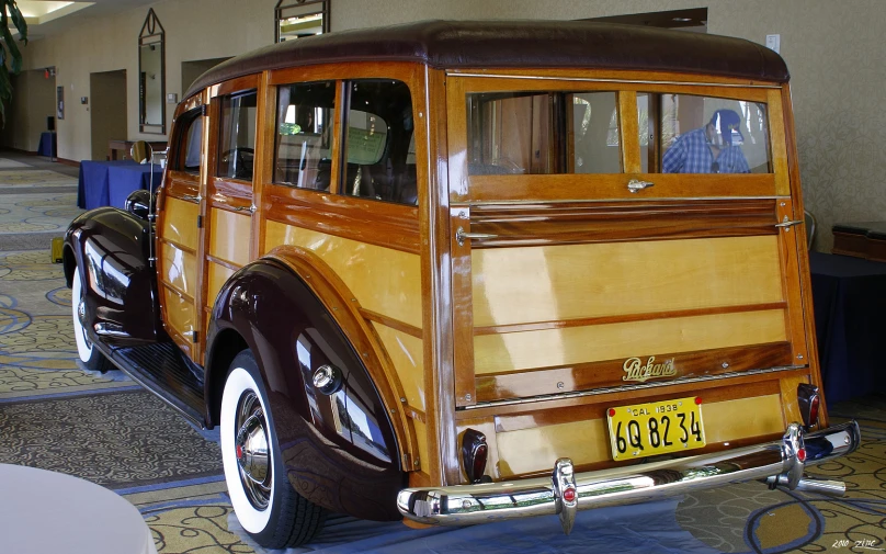 an old model wood panel automobile with a number plate