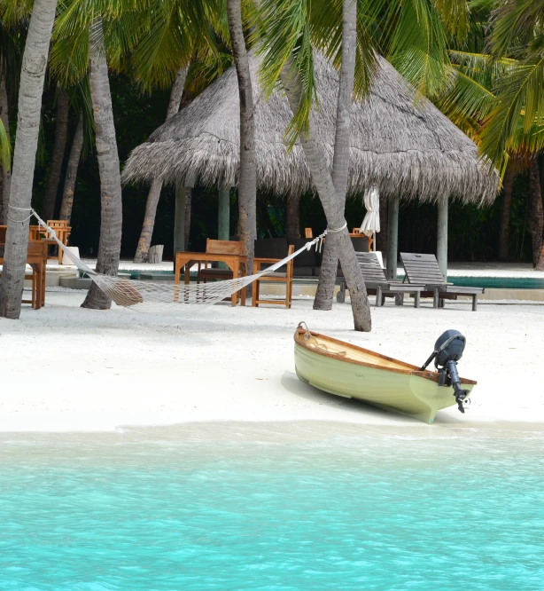 a boat sitting on top of a sandy beach