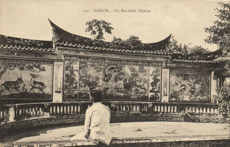 man sitting down looking at chinese art