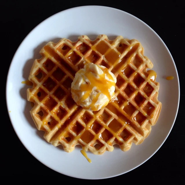 a white plate topped with waffles and er