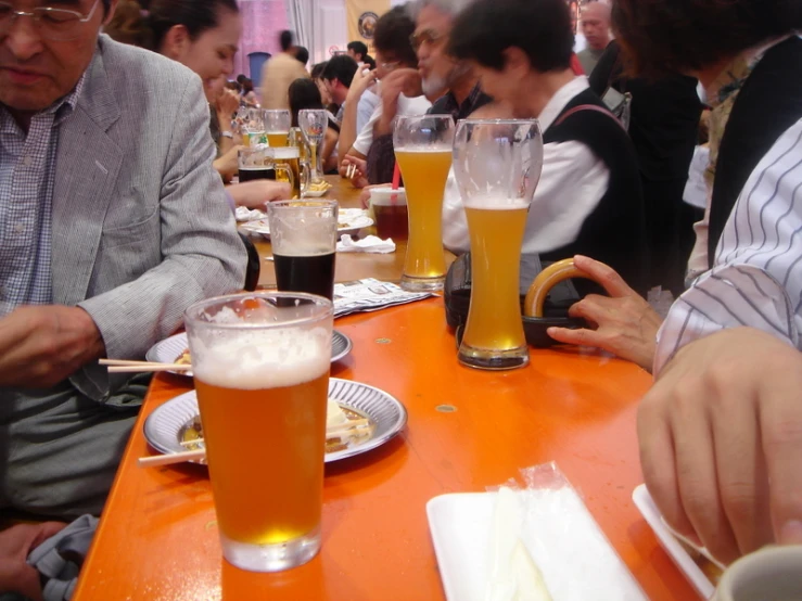 the group of people are enjoying their meal at the table