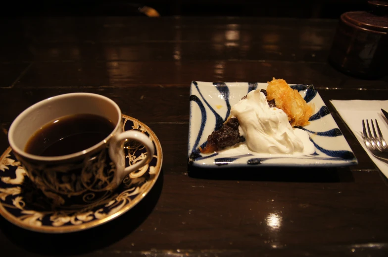 a plate of pastry and coffee are on the table