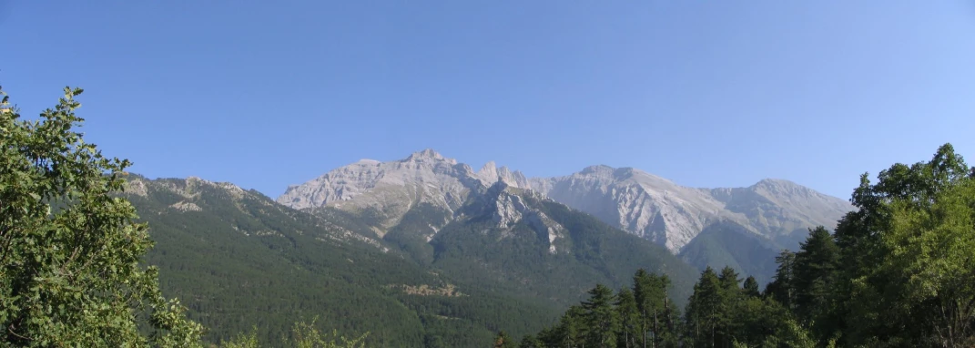 the view of mountains rise above a field