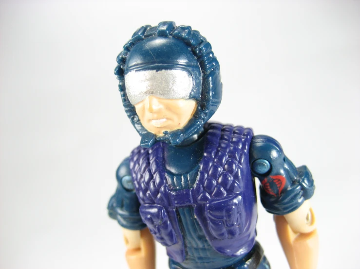 the figurine has been worn in a blue protective suit