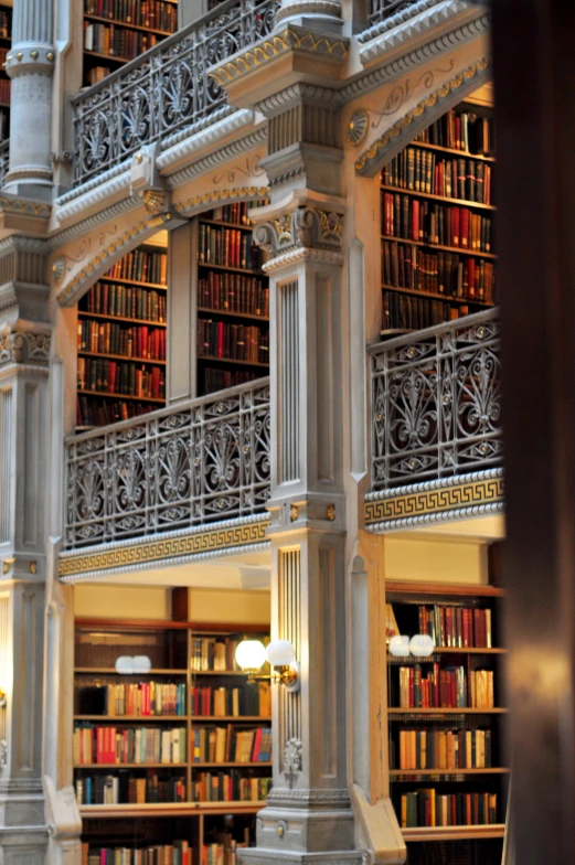 the interior of a liry with bookcases and stairs