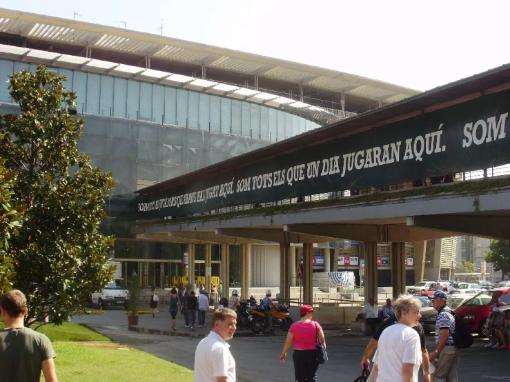 several people are walking past an open building