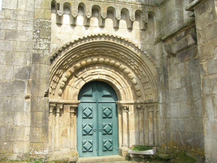 a church front with an ornate archway and blue door