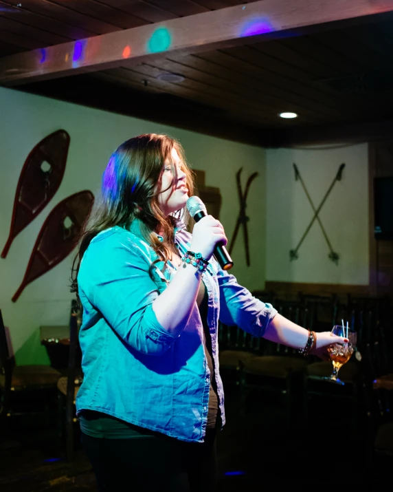 a woman singing with a microphone in her hands