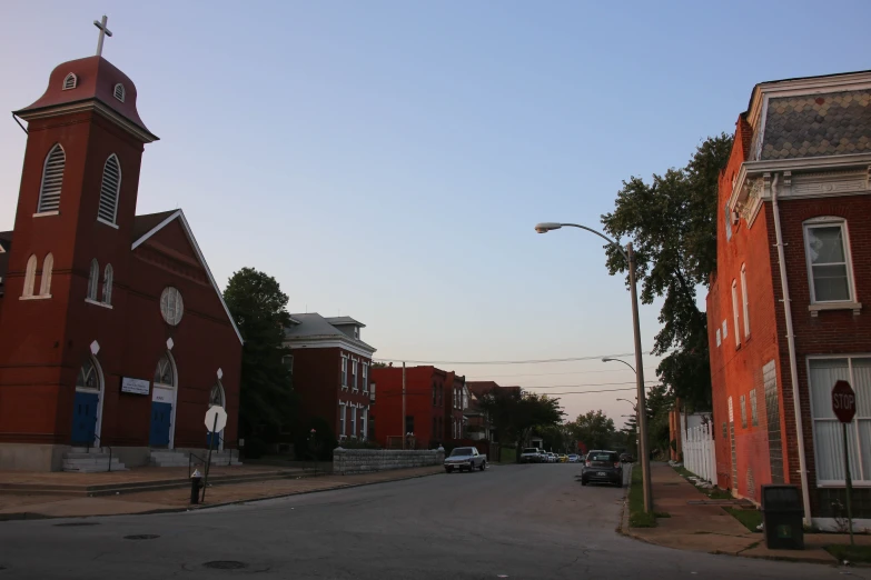 a church and another building are seen from the street