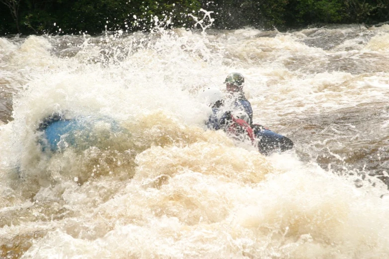 a man riding a boogie board on top of a river