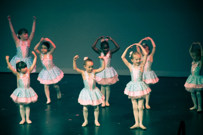 little girls dancing in a group in a school dance