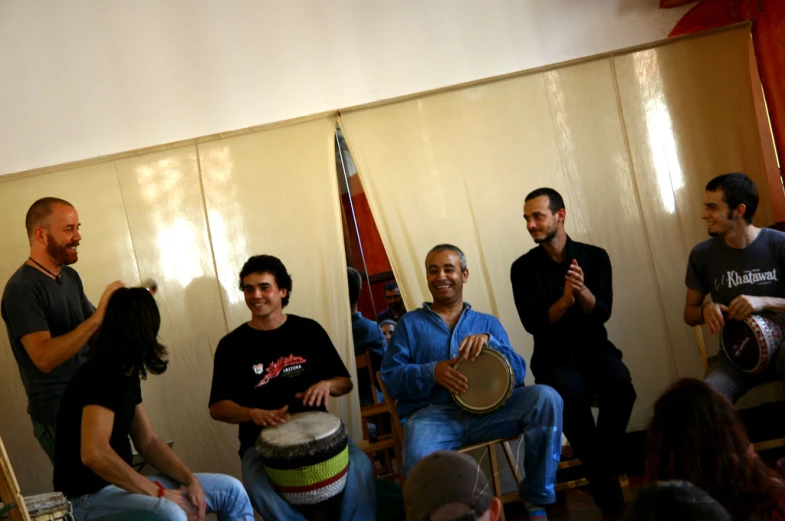 a group of people sitting around playing instruments