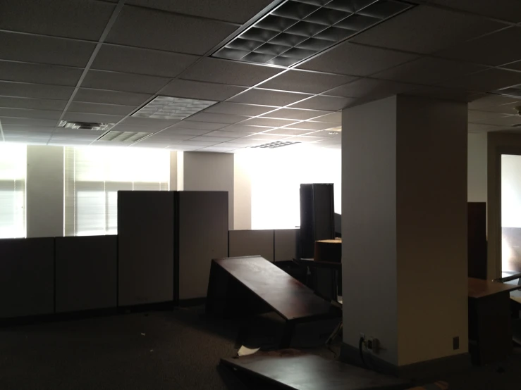 empty office cubicle with sun shining through the windows