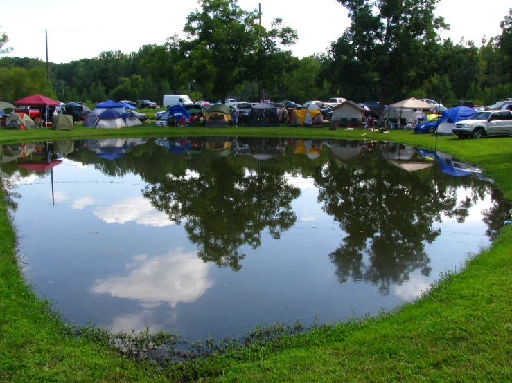 many tents are set up near the pond