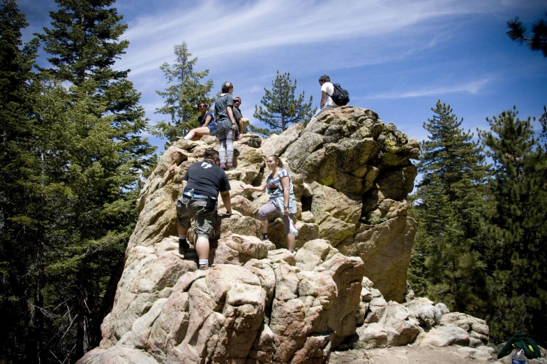 a group of people climbing up a hill