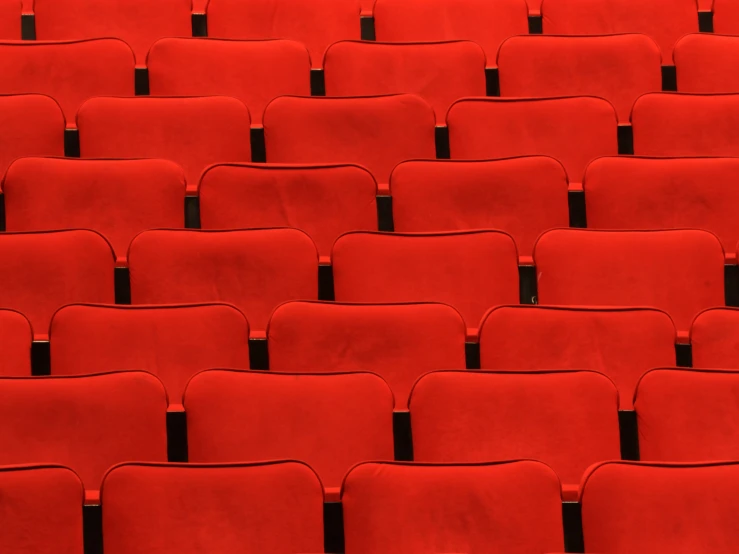 a room with some red chairs sitting in it