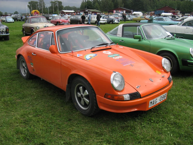 a group of classic cars parked on grass