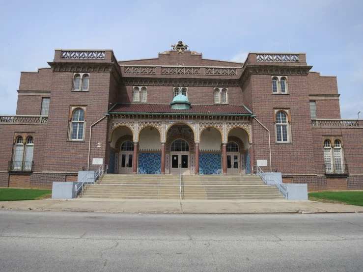 the building is made out of red brick and features decorative carvings