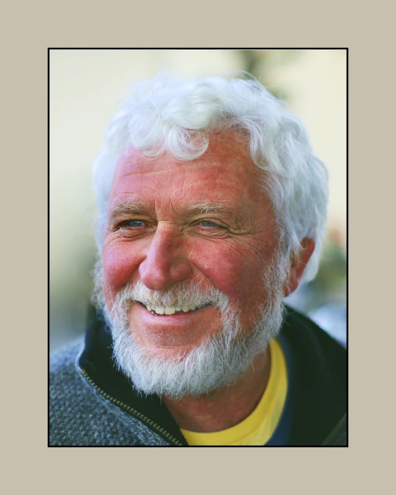 older man with white beard and yellow t - shirt