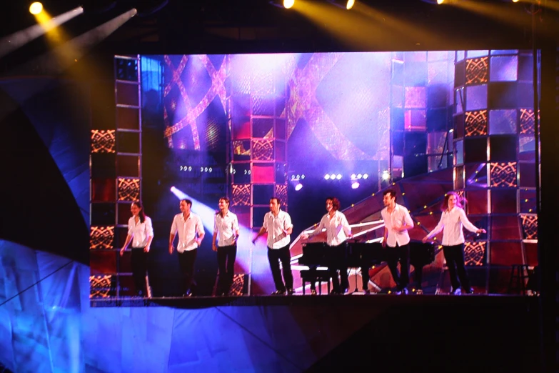 a group of young men standing on top of a stage