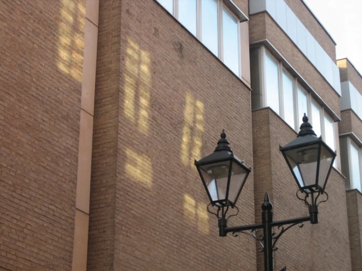 a light on the side of a brick building