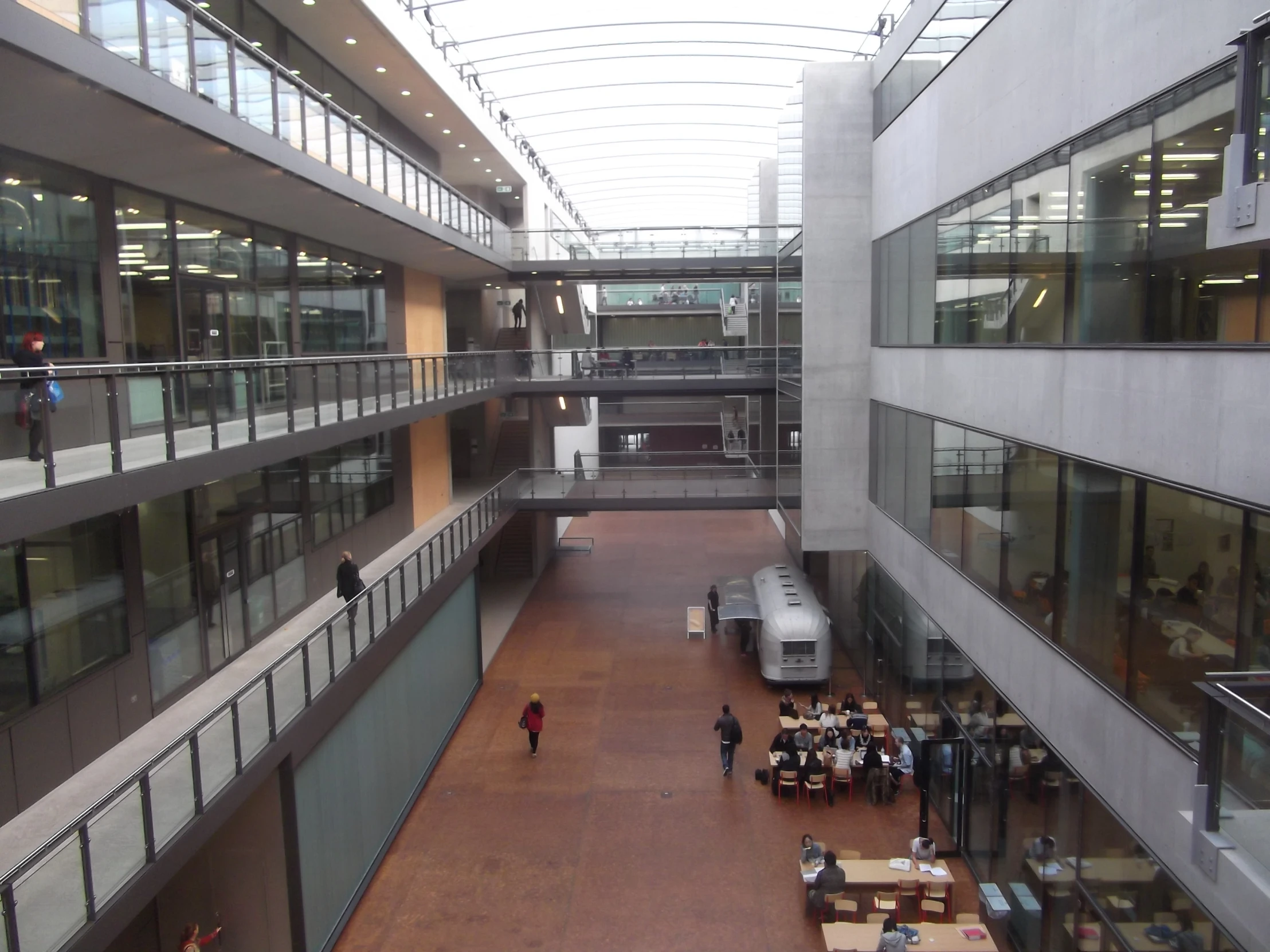 an overhead view of a building with a bus in the center