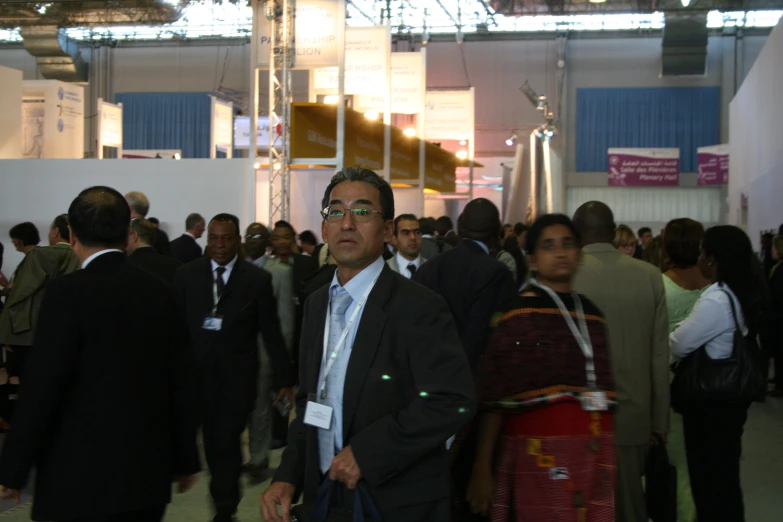 a group of people stand together in the convention hall