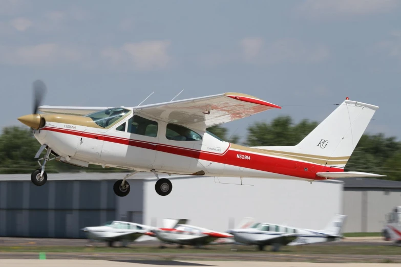 an small airplane taking off from a runway