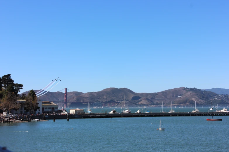 a bay view with boats and mountains on a clear day