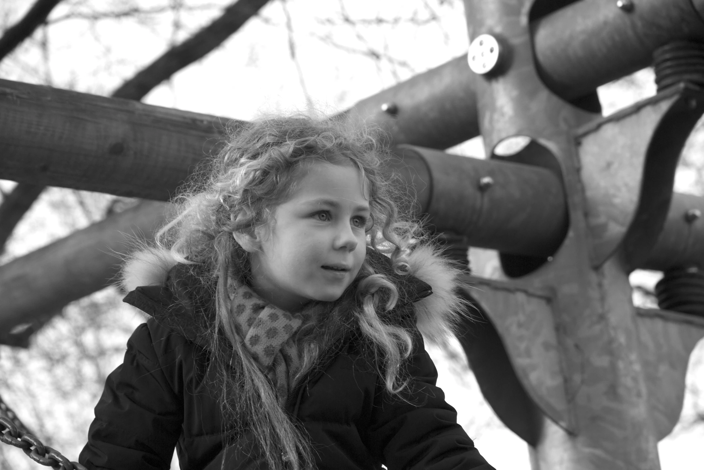 a girl is sitting on a swing set