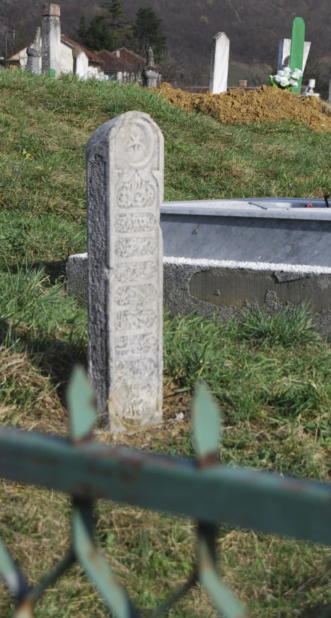 this is a cemetery marker, with grass and green grass