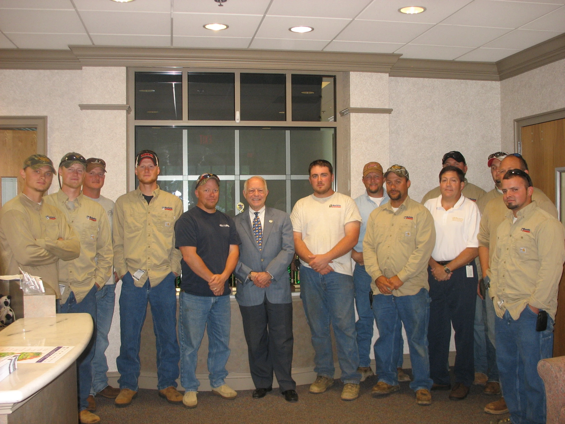 some men in work clothes posing for a picture