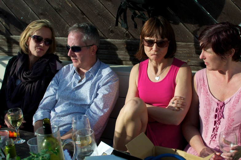 group of people sitting around at table looking bored