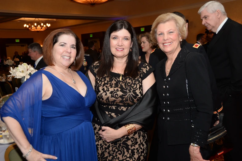 two women and a woman are posing for a picture