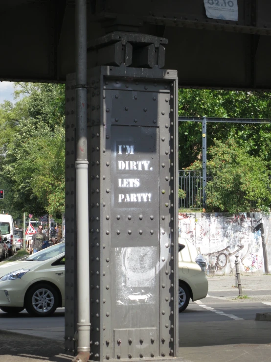 a metal sign is hanging on a pole