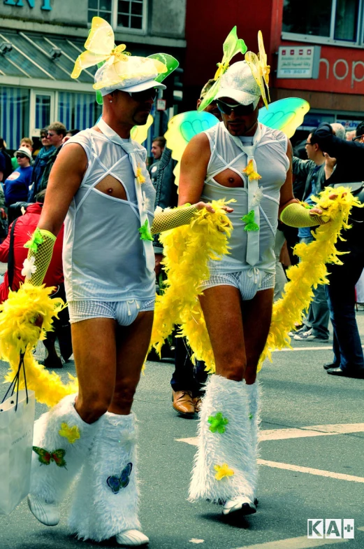 two woman in white dresses and some boots walking