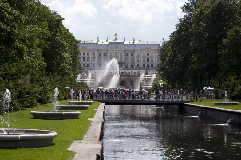 a large white palace with a large fountain near the front