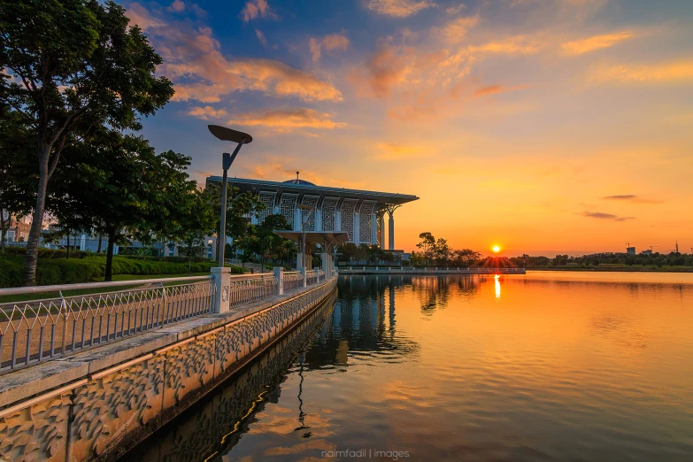 a view of the sunset and a light house along the water