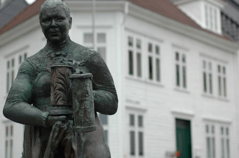 a bronze statue of a man with a bucket