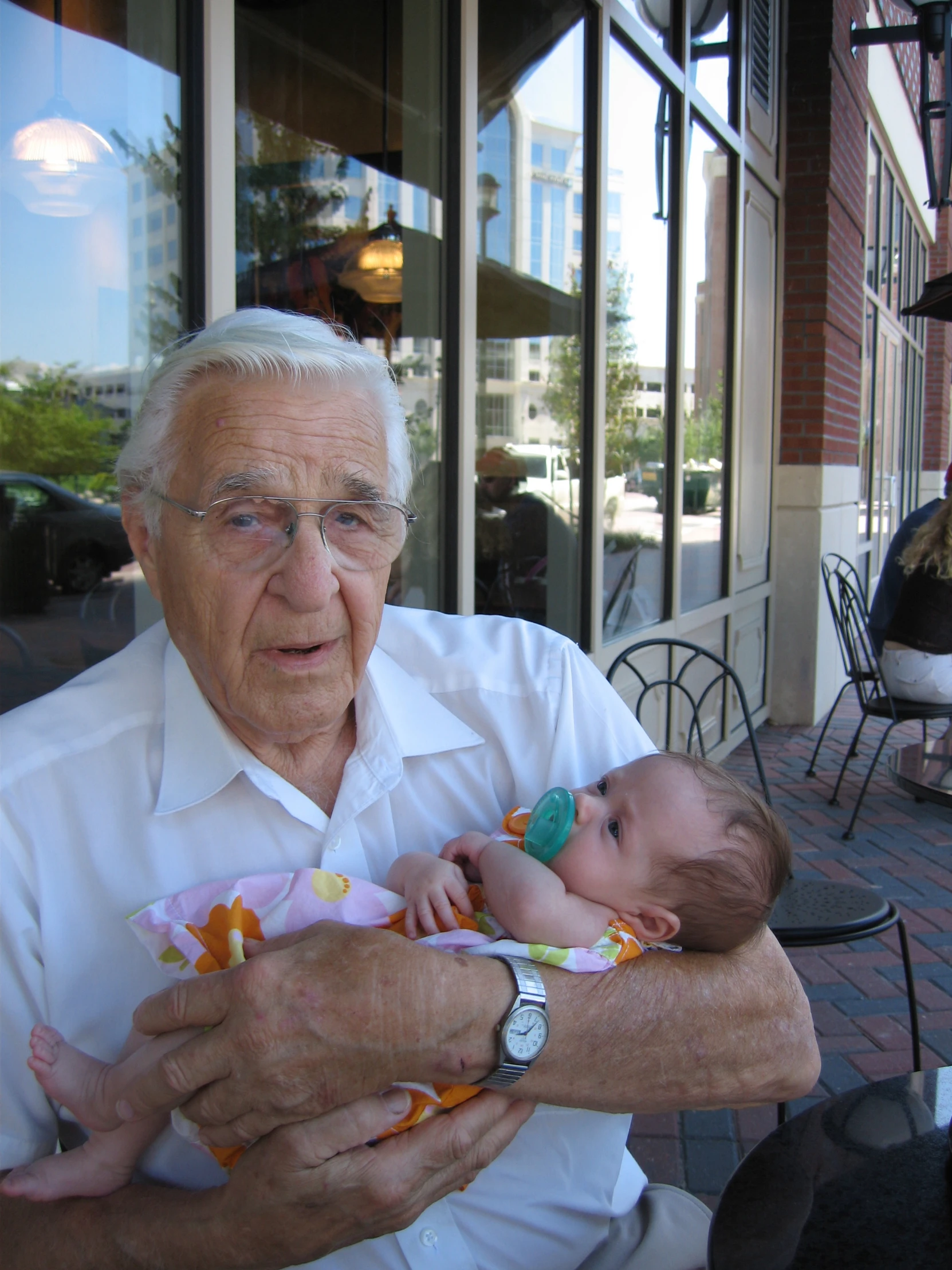 an old man is holding his baby girl for a po