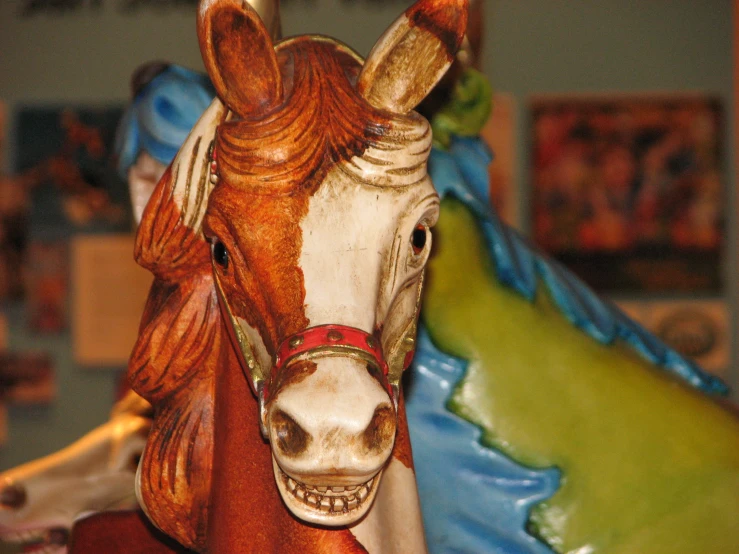 a close up of a toy horse on a wooden stand