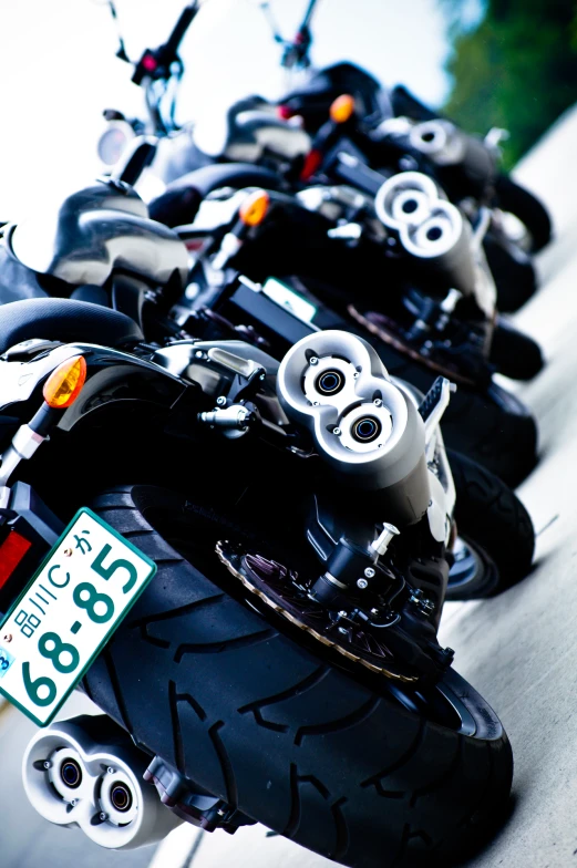 many motor bikes are lined up next to each other