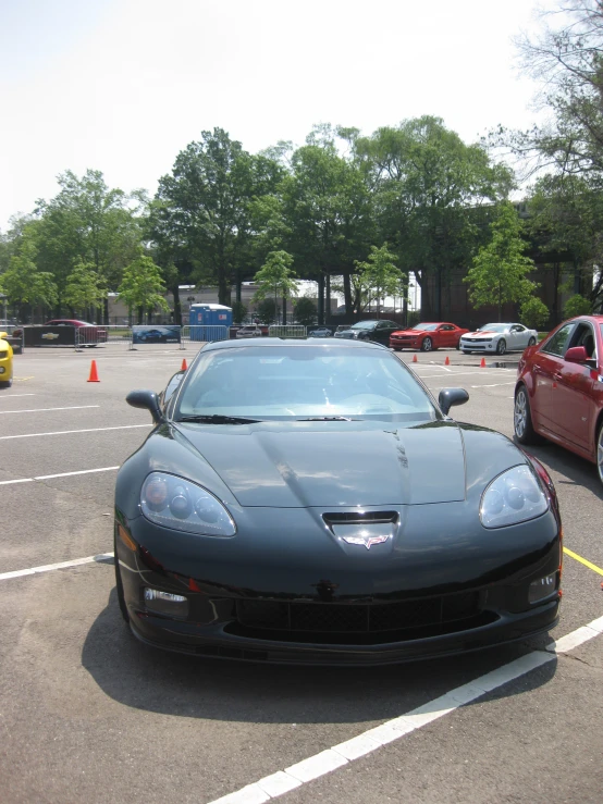 the two sports cars are parked in the lot