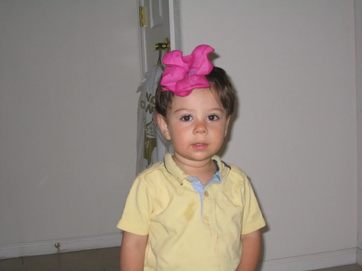 a child with a big pink hair bow on her head