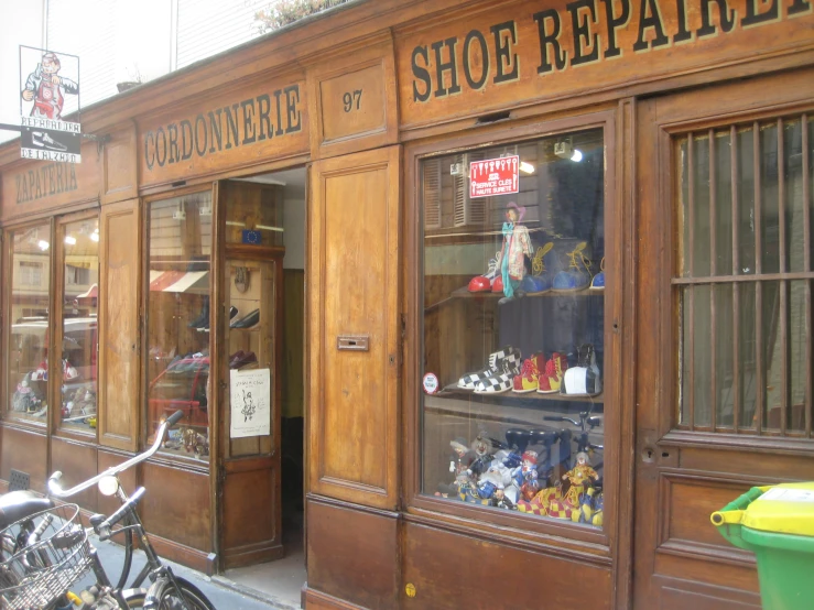 the front window of a shoe repair shop